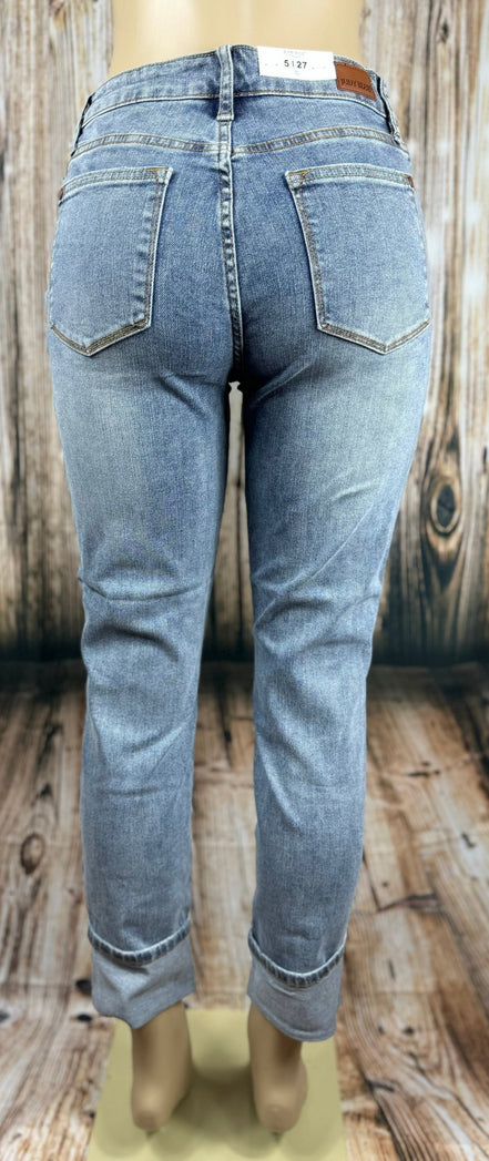 Light blue Judy Blue Boyfriend jeans displayed folded with visible stitching and relaxed fit, showcasing casual denim style.