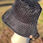 Fashion City corduroy bucket hat with wide brim and stitched detail, stylish accessory for casual and outdoor wear.