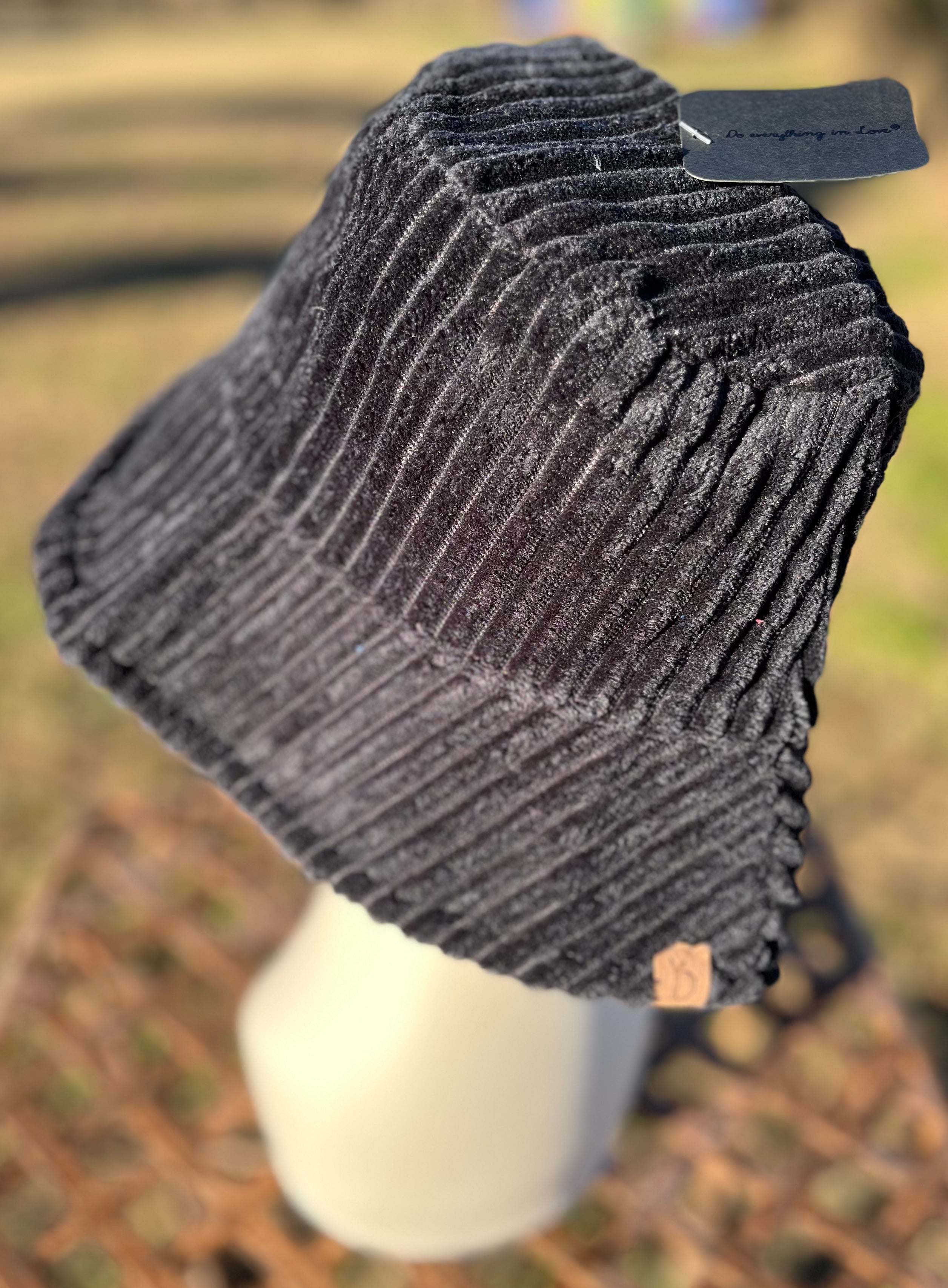 Fashion City corduroy bucket hat with wide brim and stitched detail, stylish accessory for casual and outdoor wear.