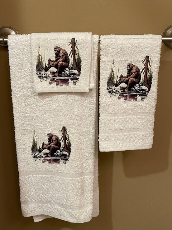 Set of three plush bath towels featuring Bigfoot design from Squatchin’ Country, perfect for a fun and cozy bathroom experience.