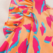 Abstract V-neck blouse with ruffled sleeves from Little Daisy Closet, showcasing a stylish top with a flowy, feminine design.