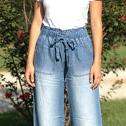 Light blue chambray pants from 42POPS with a relaxed fit, featuring a paper bag waist and front pockets.