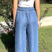 Pair of blue chambray pants from 42POPS featuring a relaxed fit, paper bag waist and front pockets,