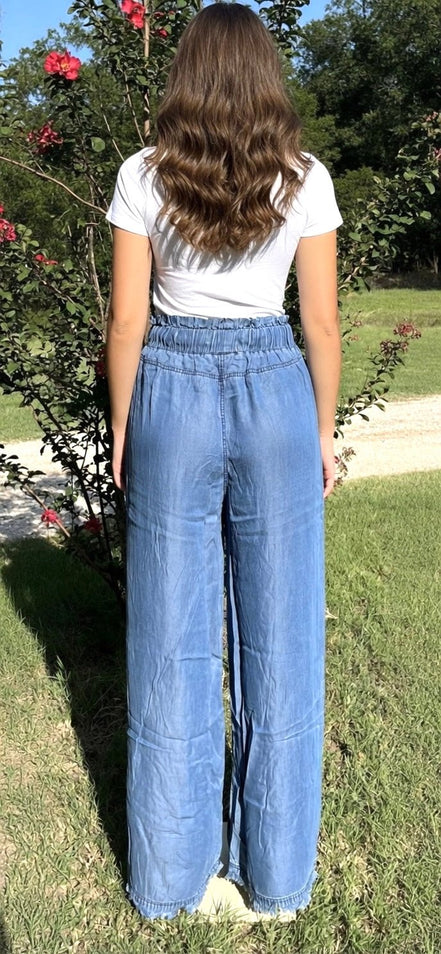 Pair of blue chambray pants from 42POPS featuring a relaxed fit, paper bag waist and front pockets,