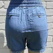 Light blue chambray shorts by 42POPS featuring a casual fit and frayed hems, perfect for summer wear.