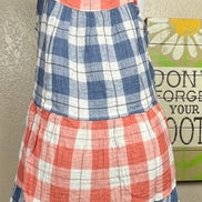 This red & blue denim checkered plaid baby doll top is tiered with a ruffled hem. Actual color may vary from images shown.