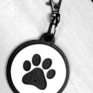 Dog paw keychain from The Country Roost featuring a detailed paw print design on a metal keyring.