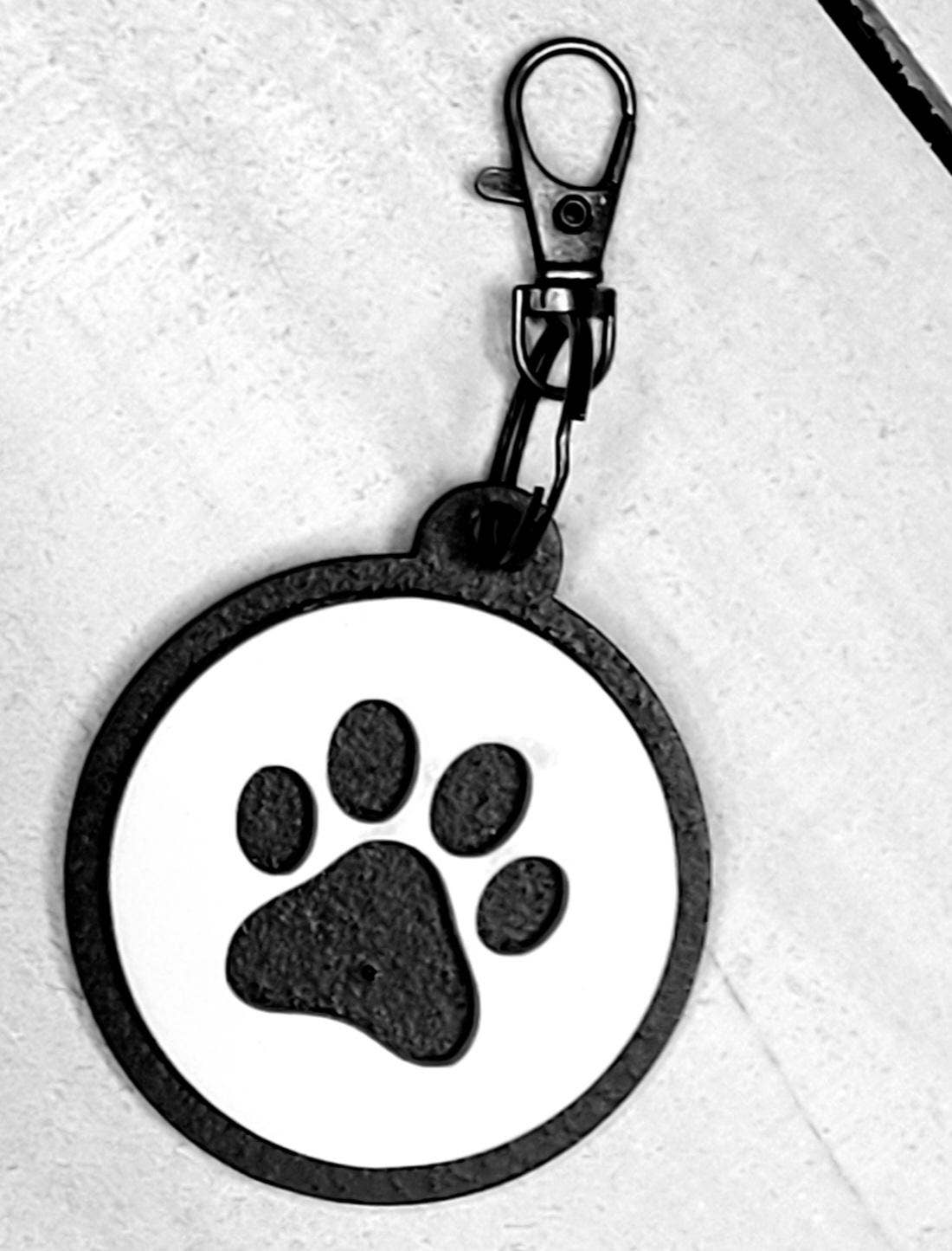 Dog paw keychain from The Country Roost featuring a detailed paw print design on a metal keyring.