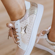 Colorful patchwork Liam & Company sneakers with textured fabric and white rubber soles, showcasing a casual shoe design.