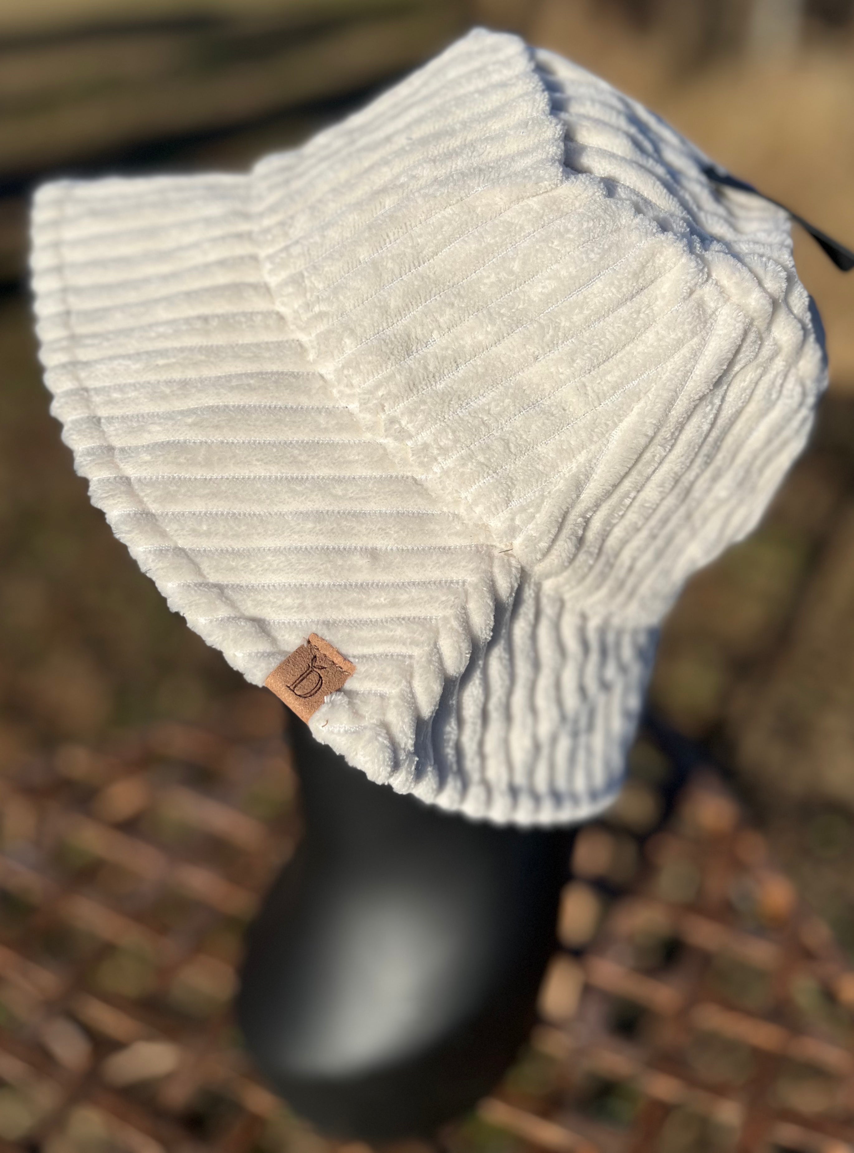 Fashion City corduroy bucket hat showing a wide brim and textured fabric in a casual style.
