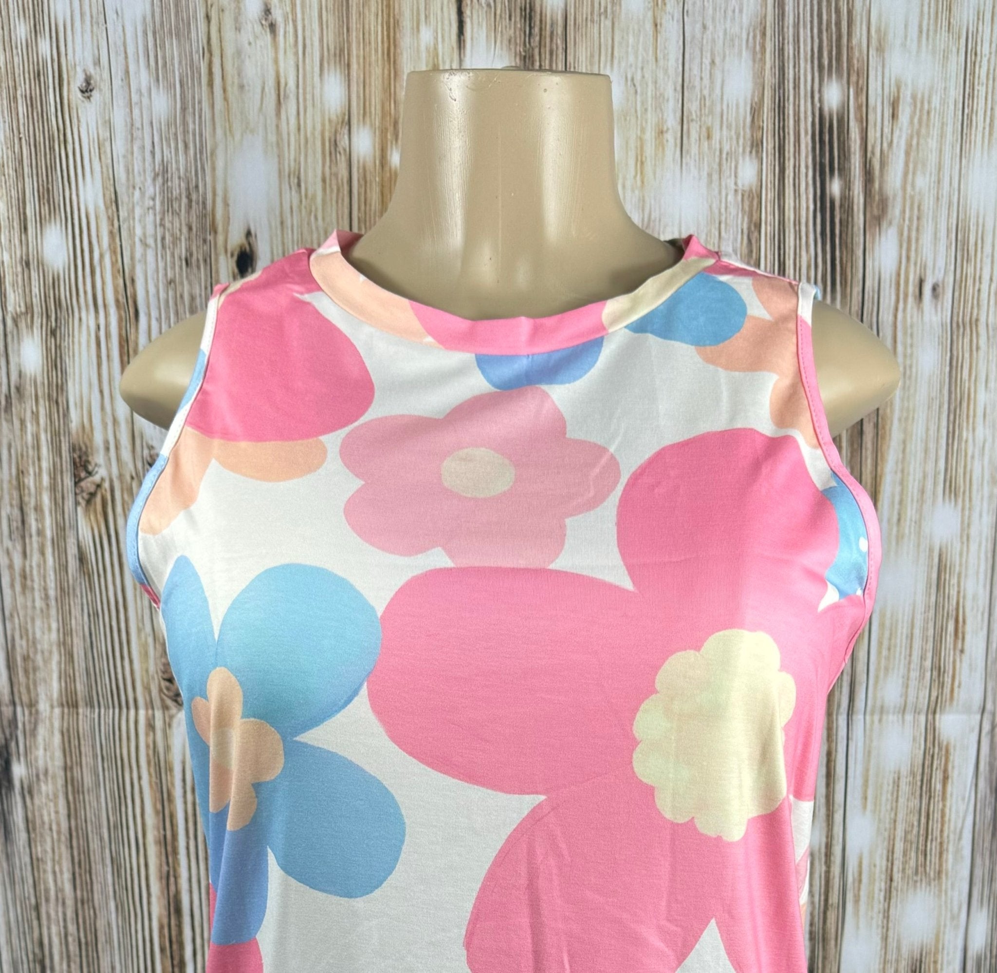 Big pink floral print tank top by Aapparella with vibrant flower patterns and lightweight fabric for a stylish summer look.