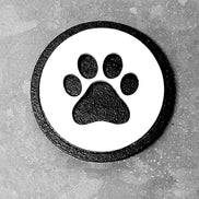 Dog paw-shaped magnet design from The Country Roost, perfect for decorating refrigerators and metal surfaces.