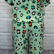 Aapparella leopard print shirt and wide-leg pants set showcasing stylish animal print fashion ensemble.