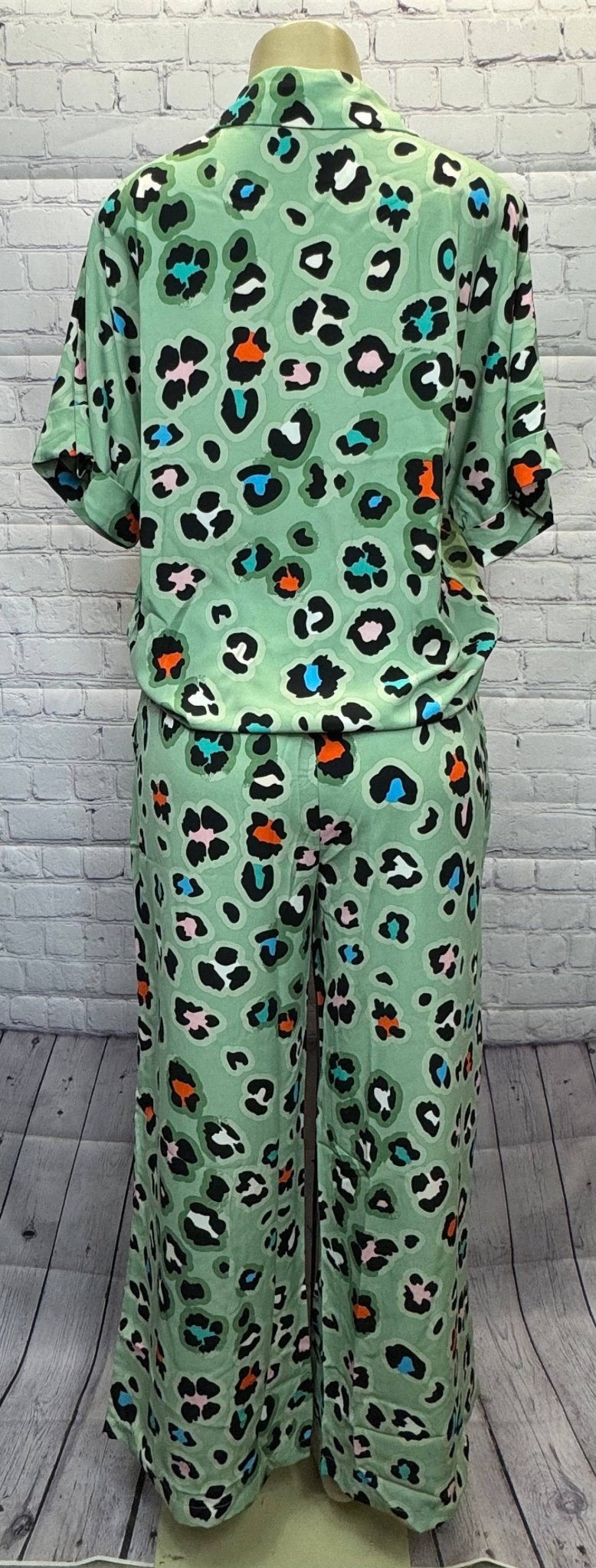 Aapparella leopard print shirt and wide-leg pants set showcasing stylish animal print fashion ensemble.