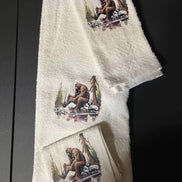 Bathing Bigfoot 3-piece towel set by Squatchin’ Country featuring plush towels with Bigfoot and forest-themed designs