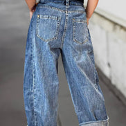A pair of stitched raw hem wide-leg loose jeans from Aapparella featuring a relaxed fit and casual style.