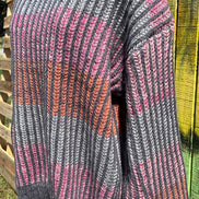 Shopin LA brand. Soft grey ribbed sweater with pink, grey and orange stripes and loose sleeves. 100% polyester. S, M, L $27
