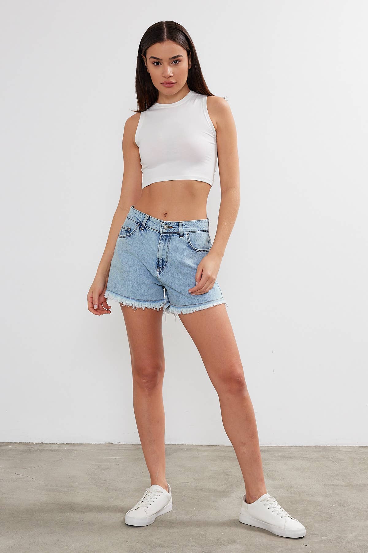Women's cropped cotton tank top with crew neck from VAV New York, featuring a basic sleeveless design and relaxed fit.