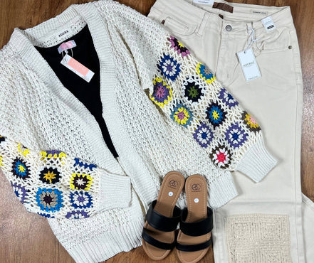 Colorful multi-pattern cardigan by ADORA LA featuring a cozy knit fabric and diverse geometric and floral designs.