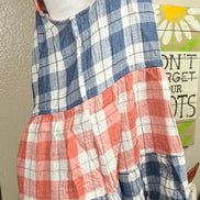 This red & blue denim checkered plaid baby doll top is tiered with a ruffled hem. Actual color may vary from images shown.
