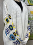 ADORA LA multi-pattern cardigan featuring various colorful knit designs, long sleeves, and a cozy, stylish fit.