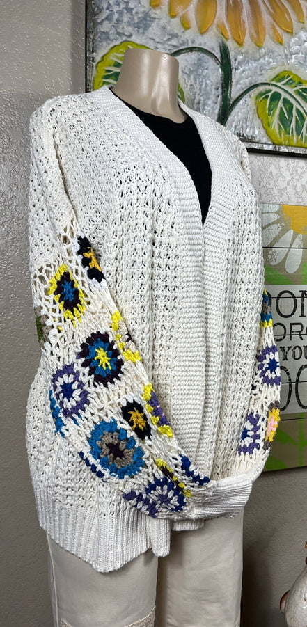 ADORA LA multi-pattern cardigan featuring various colorful knit designs, long sleeves, and a cozy, stylish fit.