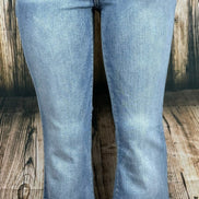 Judy Blue flared jeans featuring a high waist and distressed details, shown on a model with a casual, stylish look.