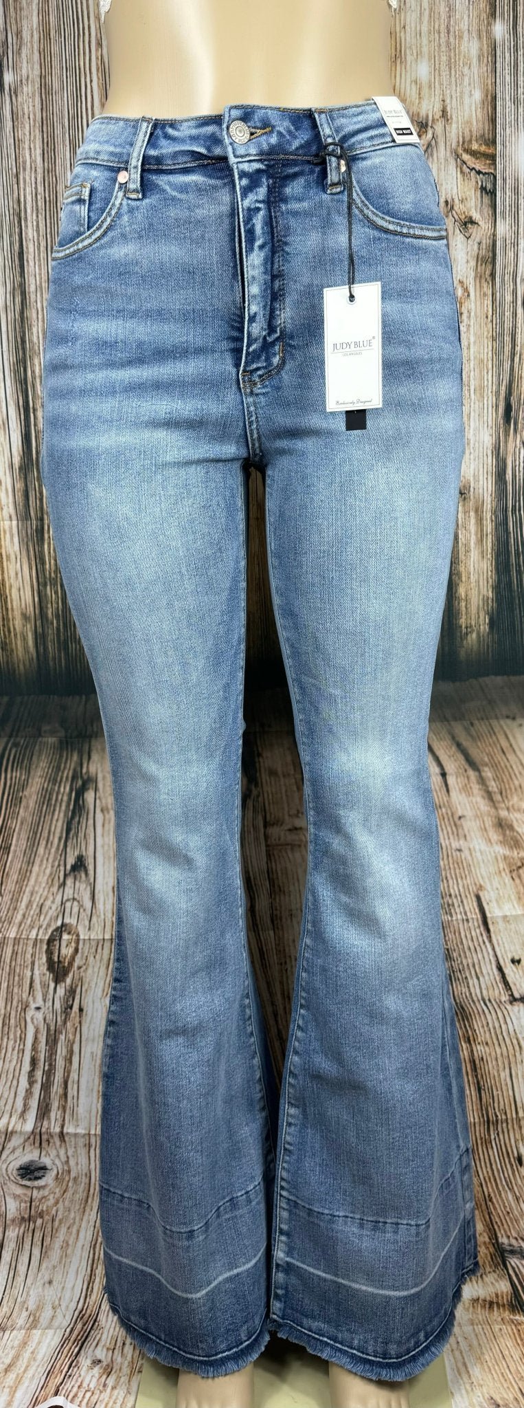 Judy Blue flared jeans featuring a high waist and distressed details, shown on a model with a casual, stylish look.
