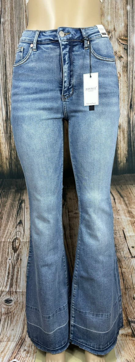 Judy Blue flared jeans featuring a high waist and distressed details, shown on a model with a casual, stylish look.