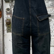 Light blue washed denim casual overalls by ADORA LA, featuring adjustable straps and front pocket, worn by a model.