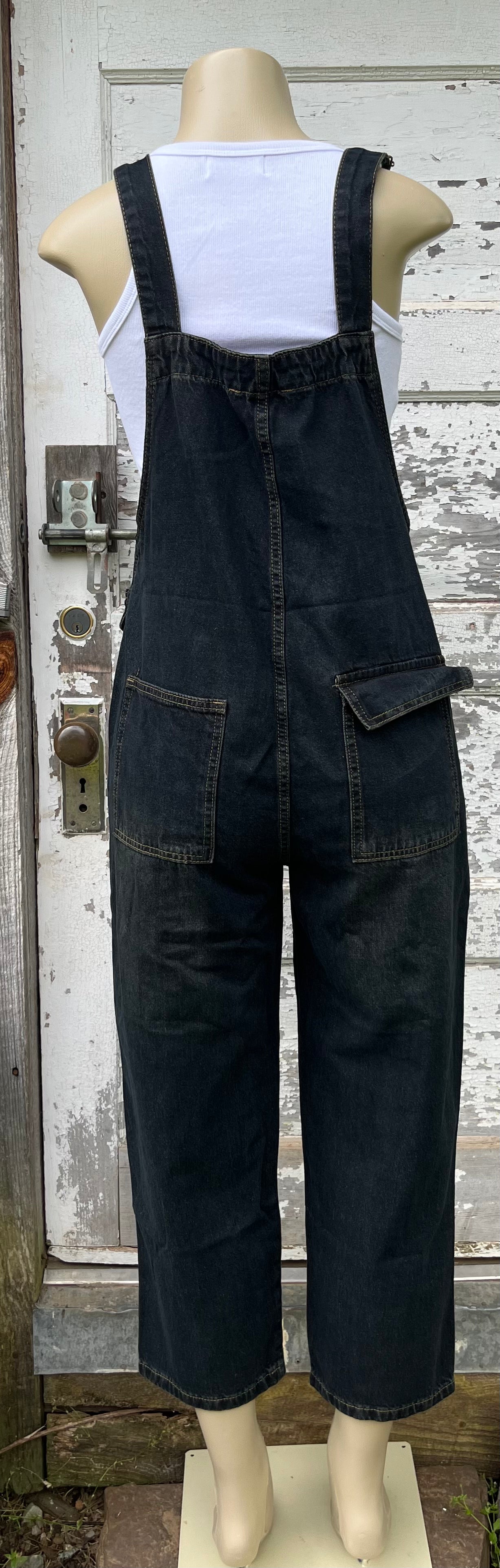 Light blue washed denim casual overalls by ADORA LA, featuring adjustable straps and front pocket, worn by a model.