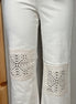 Judy Blue ecru jeans with crocheted patches featuring intricate stitching and textured fabric details.