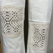 Judy Blue Ecru Crocheted Patches denim jeans showing detailed stitched patches and distressed fabric on the thigh area.