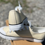 Pair of classic FASHION EMPORIO sneakers in white with laces, showcasing a casual and stylish footwear option.