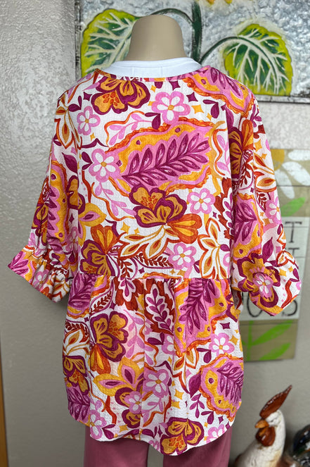 ADORA LA peasant floral top featuring a lightweight, bohemian-inspired design with colorful floral patterns and relaxed fit.