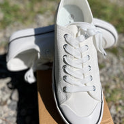FASHION EMPORIO classic sneakers in white with black accents, showing the full side view of the stylish casual footwear.
