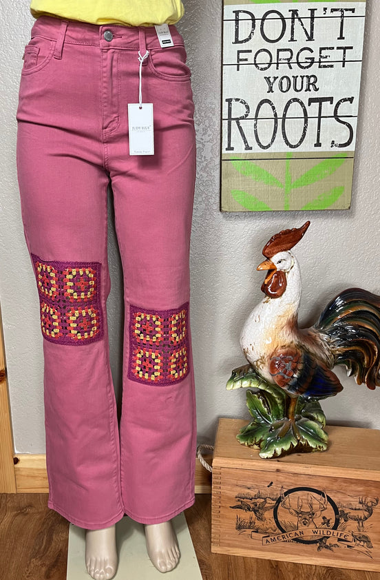 Judy Blue wide-leg jeans with crocheted patch details and a relaxed fit, showcasing the stylish denim design.