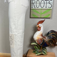 Judy Blue ecru jeans with crocheted patches, showcasing detailed beige and white crochet designs on denim fabric.