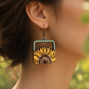 Hand-painted maple wood sunflower earrings by Seasideblooms featuring boho style and vibrant floral design.