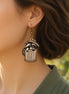 Hand-painted raccoon earrings made of lightweight maple wood by Seasideblooms, featuring detailed animal design and natural wood finish.
