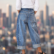 Aapparella stitched raw hem wide-leg loose jeans, showing the relaxed fit and distressed raw hem detail on denim pants.