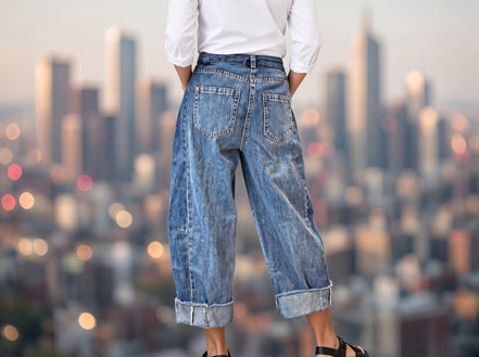 Aapparella stitched raw hem wide-leg loose jeans, showing the relaxed fit and distressed raw hem detail on denim pants.