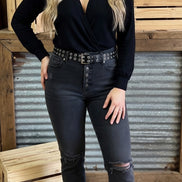 Black skinny jeans by VERVET by FLYING MONKEY with a close-up of the denim fabric and front pockets.