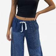 American Recycled Clothing denim eco jeans showing a relaxed fit and classic five-pocket design on a model.