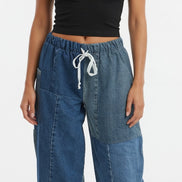 Blue denim eco jeans by American Recycled Clothing, showing the relaxed fit and classic five-pocket design.