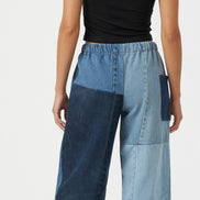 Pair of American Recycled Clothing denim eco jeans showing classic fit and medium wash fabric with visible stitching.