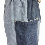 Pair of American Recycled Clothing denim eco jeans showing classic fit and medium wash, with visible stitching and five-pocket design.