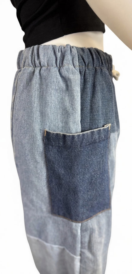 Pair of American Recycled Clothing denim eco jeans showing classic fit and medium wash, with visible stitching and five-pocket design.