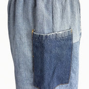Pair of American Recycled Clothing denim eco jeans showing classic fit, five-pocket design, and medium wash fabric.