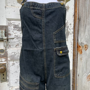 Light blue washed denim casual overalls by ADORA LA featuring adjustable straps and front pockets, displayed on a hanger.